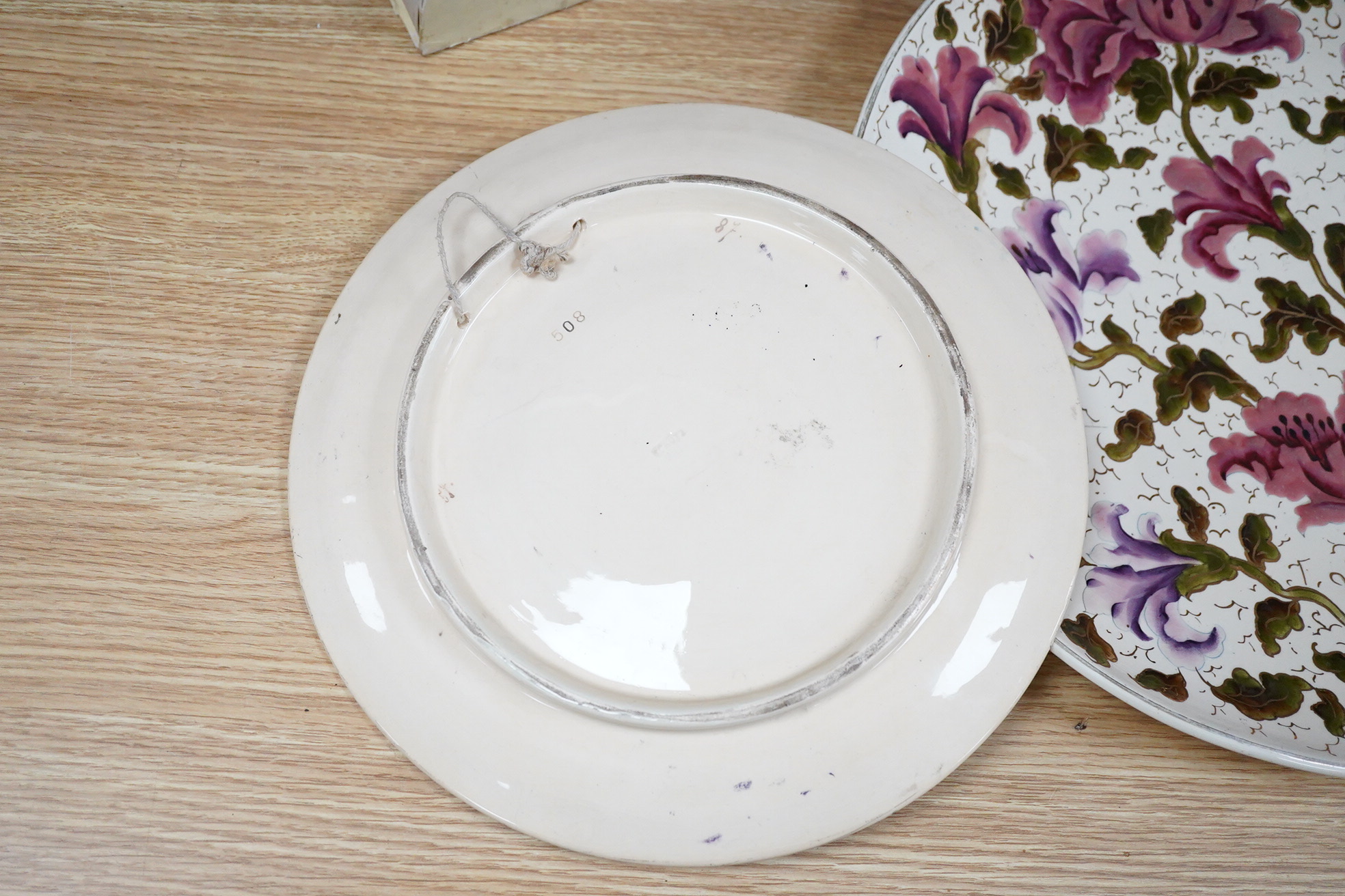 A Zsolnay-type floral charger, 39cm diameter and similar smaller Schutz Cilli plate